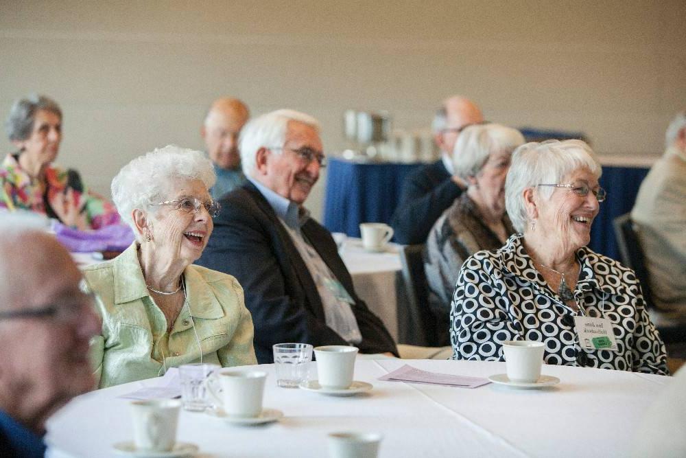 Grand Forum members smile during a lecture